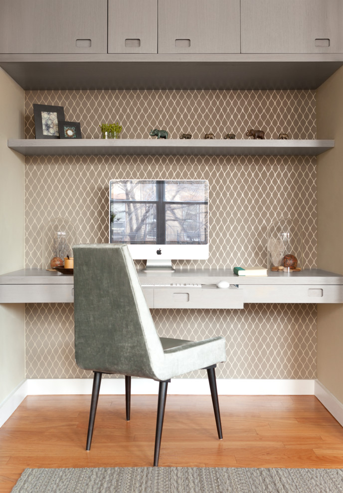 Home office - mid-sized contemporary built-in desk light wood floor home office idea in New York with no fireplace