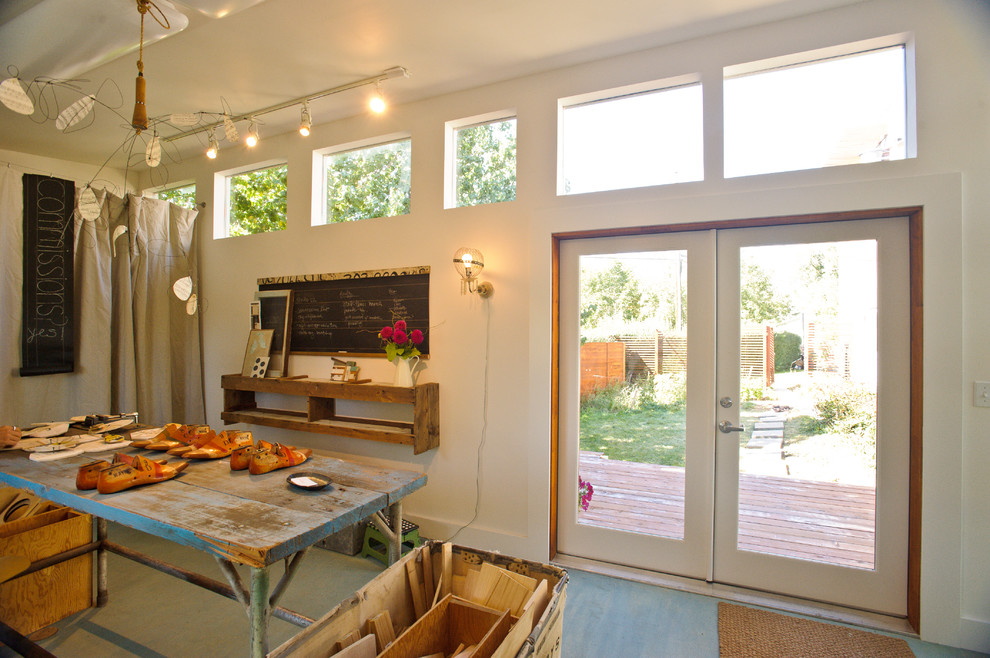 Craft room - modern painted wood floor and turquoise floor craft room idea in Denver with white walls