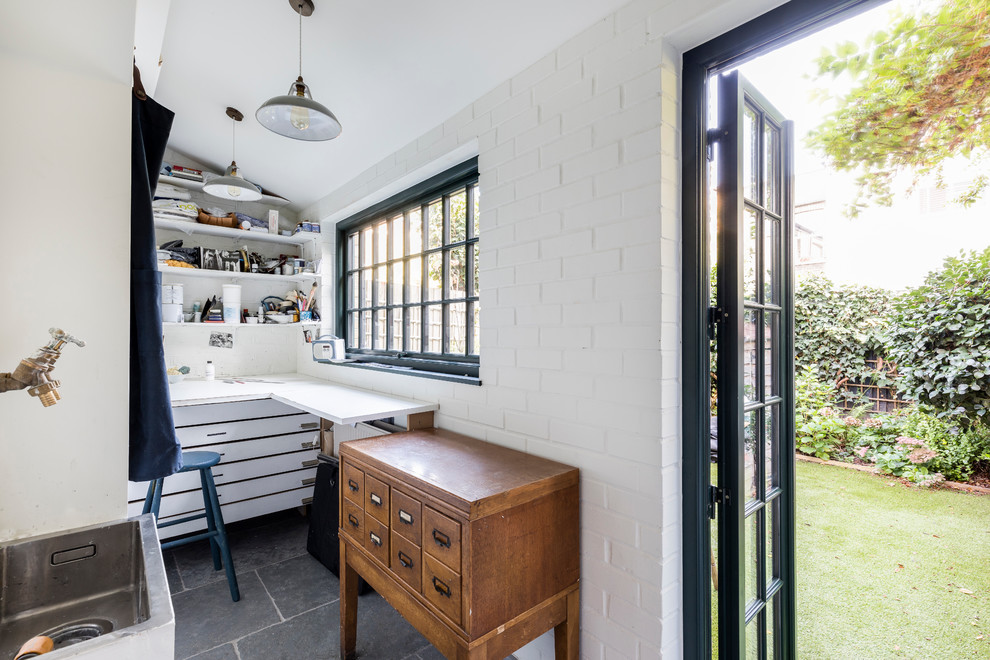Kleines Industrial Nähzimmer ohne Kamin mit weißer Wandfarbe, Kalkstein, Einbau-Schreibtisch und grauem Boden in London