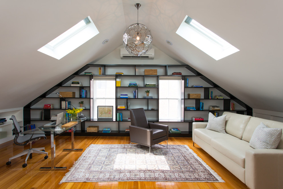 Medium sized contemporary study in Boston with white walls, medium hardwood flooring, no fireplace and a freestanding desk.