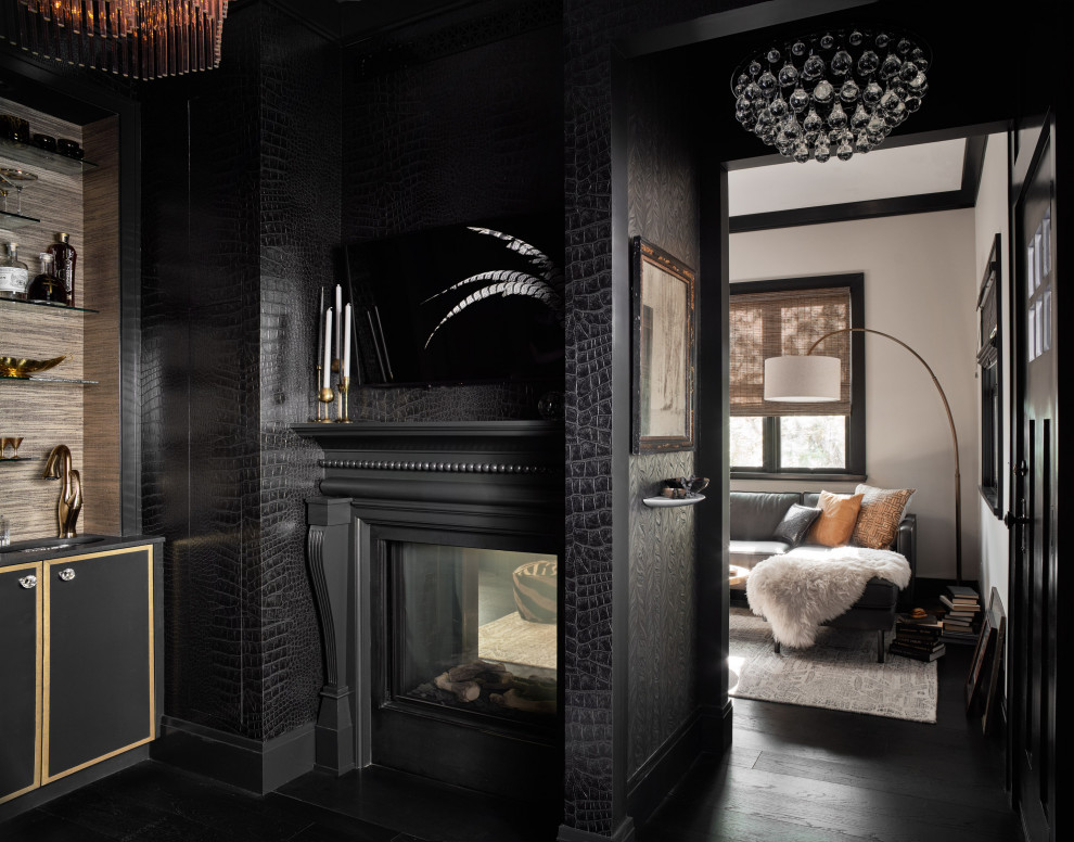 Inspiration pour un bureau traditionnel de taille moyenne avec un mur noir, parquet foncé, une cheminée double-face, un manteau de cheminée en bois et un sol noir.
