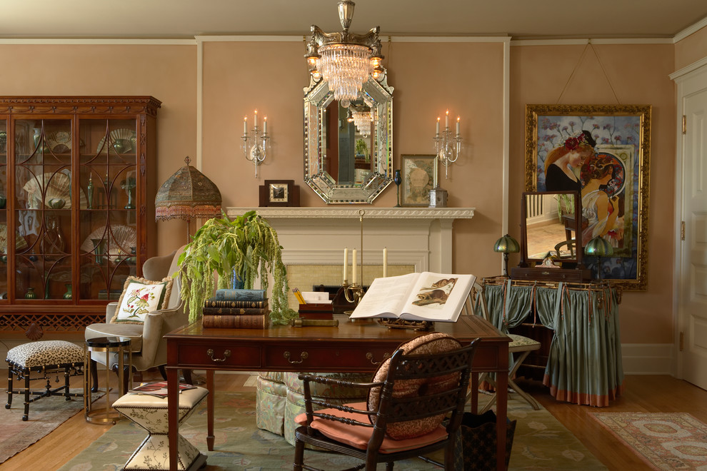 Klassisches Arbeitszimmer mit braunem Holzboden, freistehendem Schreibtisch, Arbeitsplatz, Kamin, gefliester Kaminumrandung und beiger Wandfarbe in Minneapolis