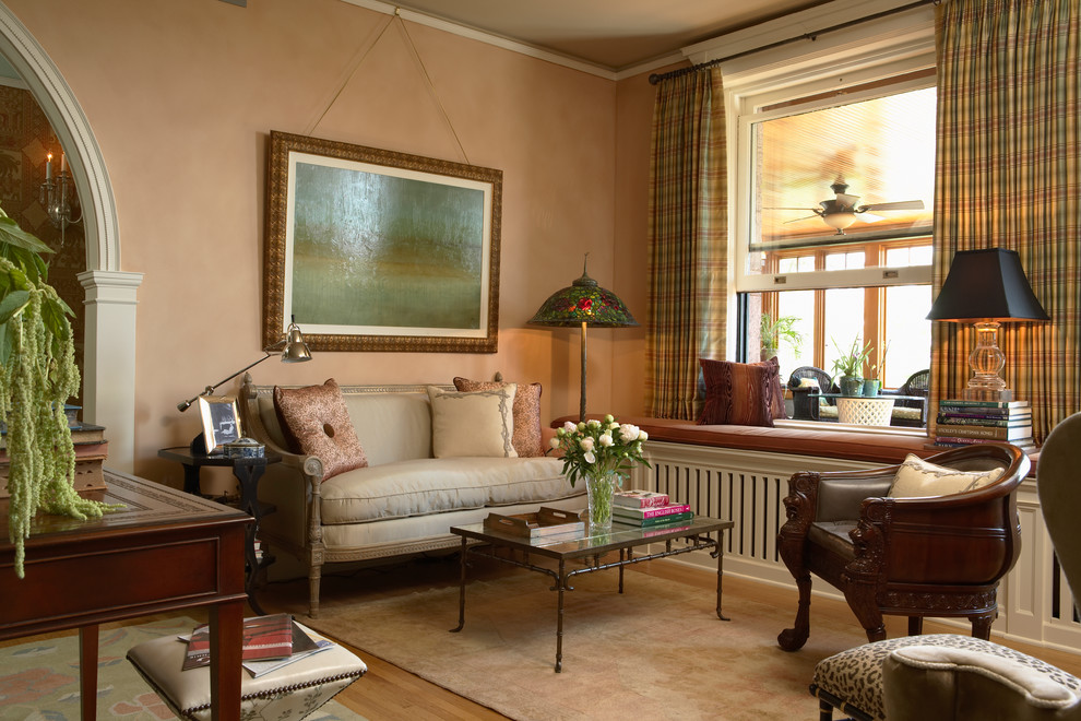 Inspiration for a timeless freestanding desk medium tone wood floor study room remodel in Minneapolis with beige walls