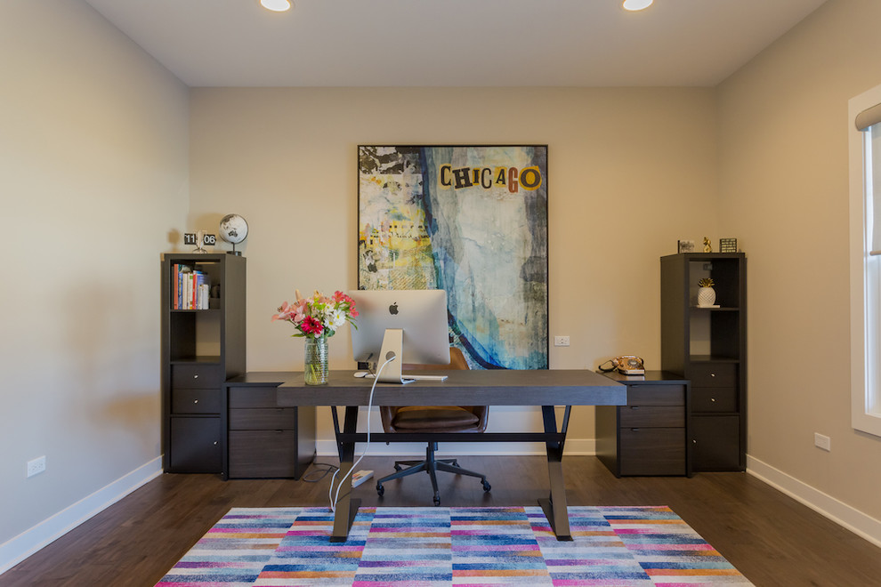 Inspiration for a large modern freestanding desk medium tone wood floor study room remodel in Chicago with gray walls
