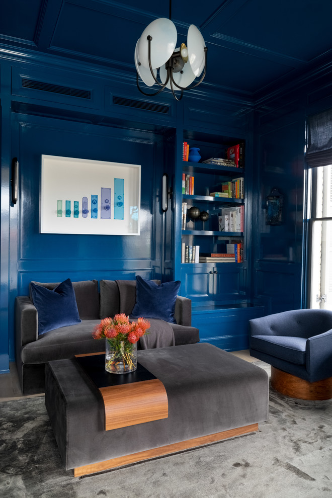 This is an example of a large traditional home office in Austin with blue walls, grey floors, a reading nook and feature lighting.