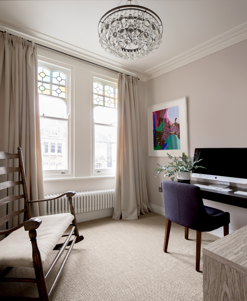 Small classic study in London with beige walls, a built-in desk and beige floors.