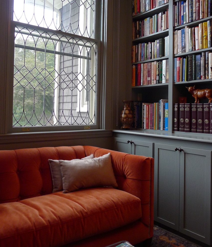This is an example of a medium sized classic study in Baltimore with grey walls and a freestanding desk.