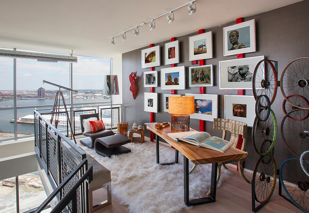 Inspiration for a small industrial freestanding desk light wood floor and brown floor study room remodel in DC Metro with gray walls and no fireplace