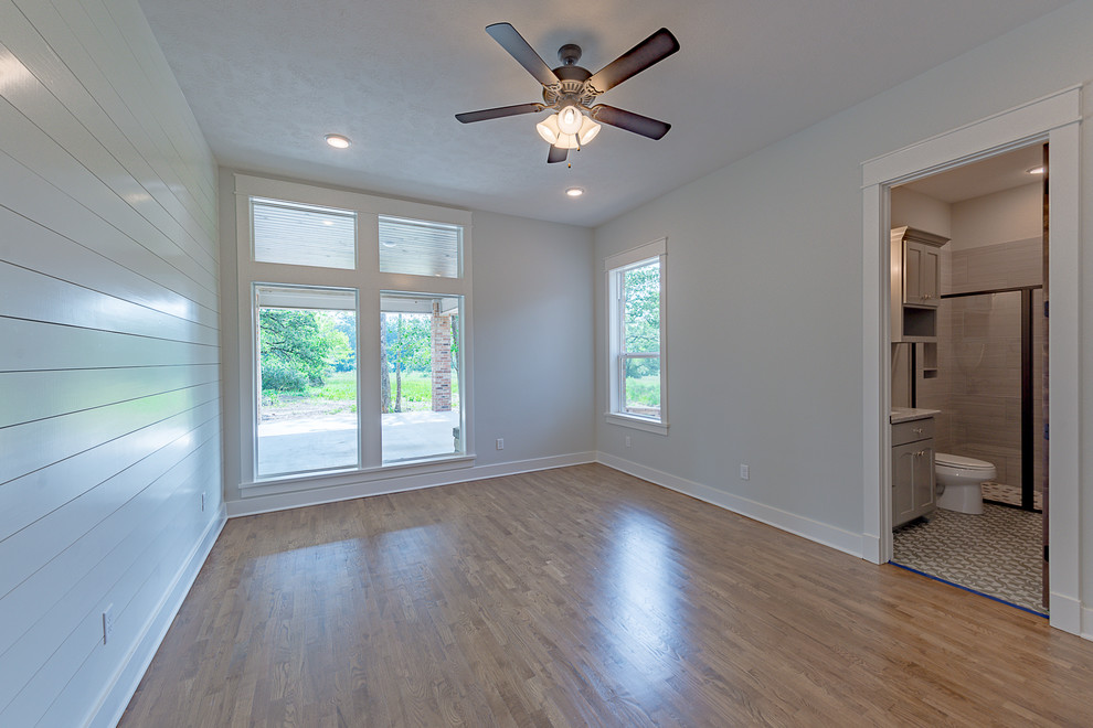 Craft room - mid-sized farmhouse dark wood floor, brown floor and shiplap wall craft room idea in Other with gray walls