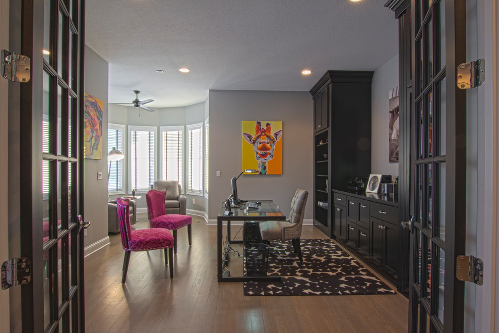 Photo of a medium sized contemporary study in Minneapolis with grey walls, light hardwood flooring and a freestanding desk.