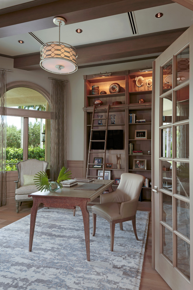 Medium sized classic study in Other with beige walls, medium hardwood flooring and a freestanding desk.