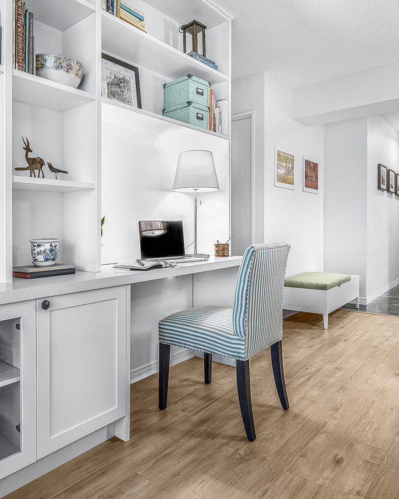 Example of a mid-sized transitional built-in desk porcelain tile and beige floor study room design in Toronto with white walls