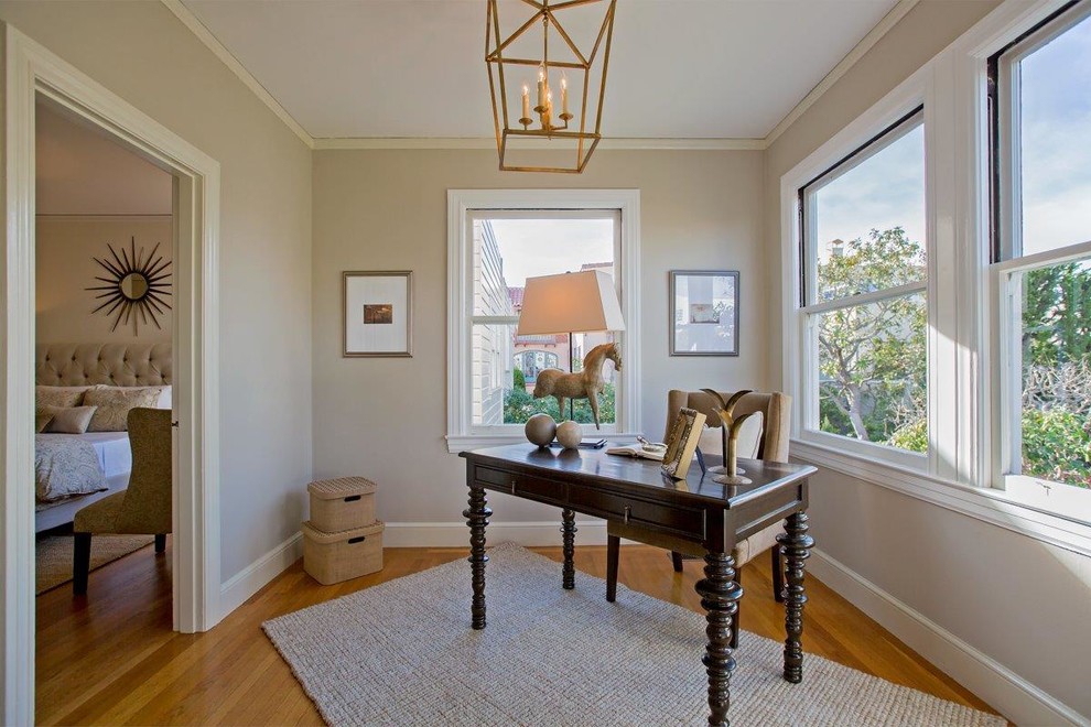 Example of a mid-sized classic freestanding desk light wood floor and brown floor study room design in San Francisco with beige walls and no fireplace