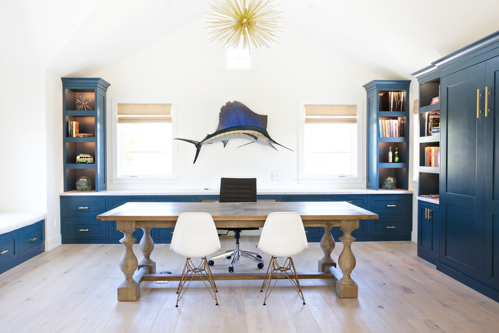 Photo of a beach style home office in Salt Lake City with white walls, light hardwood flooring, no fireplace, a freestanding desk and beige floors.