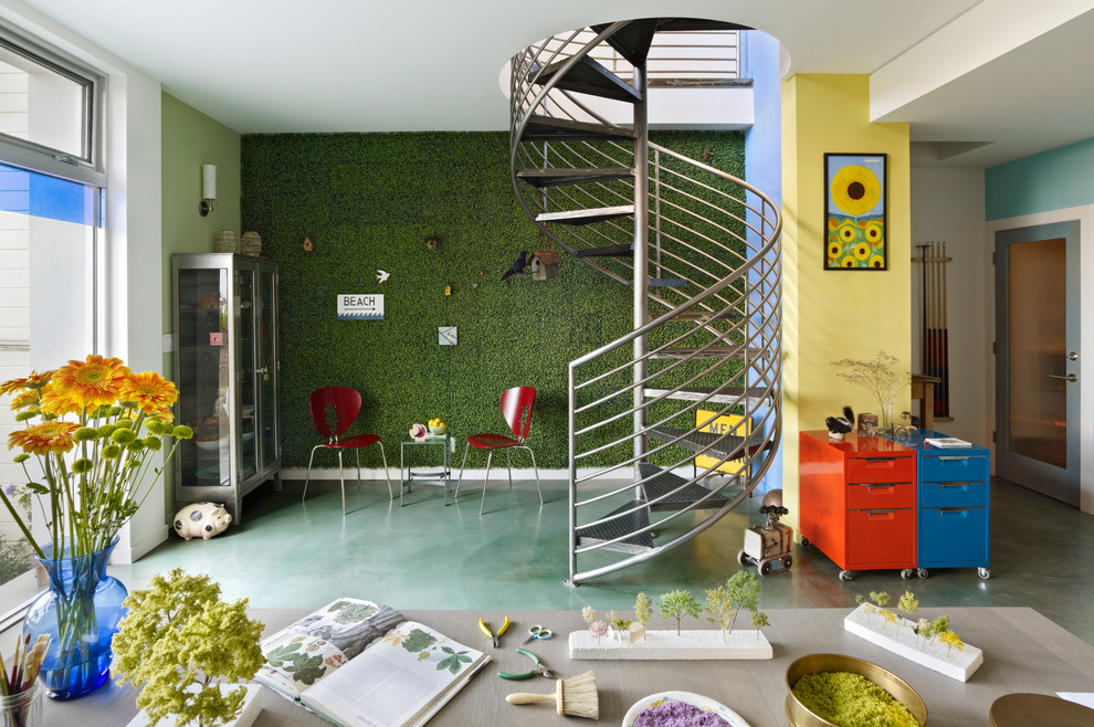 Photo of an eclectic home studio in San Francisco with multi-coloured walls, concrete flooring, no fireplace and green floors.