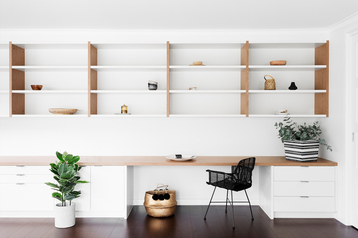 Photo of a medium sized scandi study in Melbourne with white walls, dark hardwood flooring, a built-in desk and brown floors.