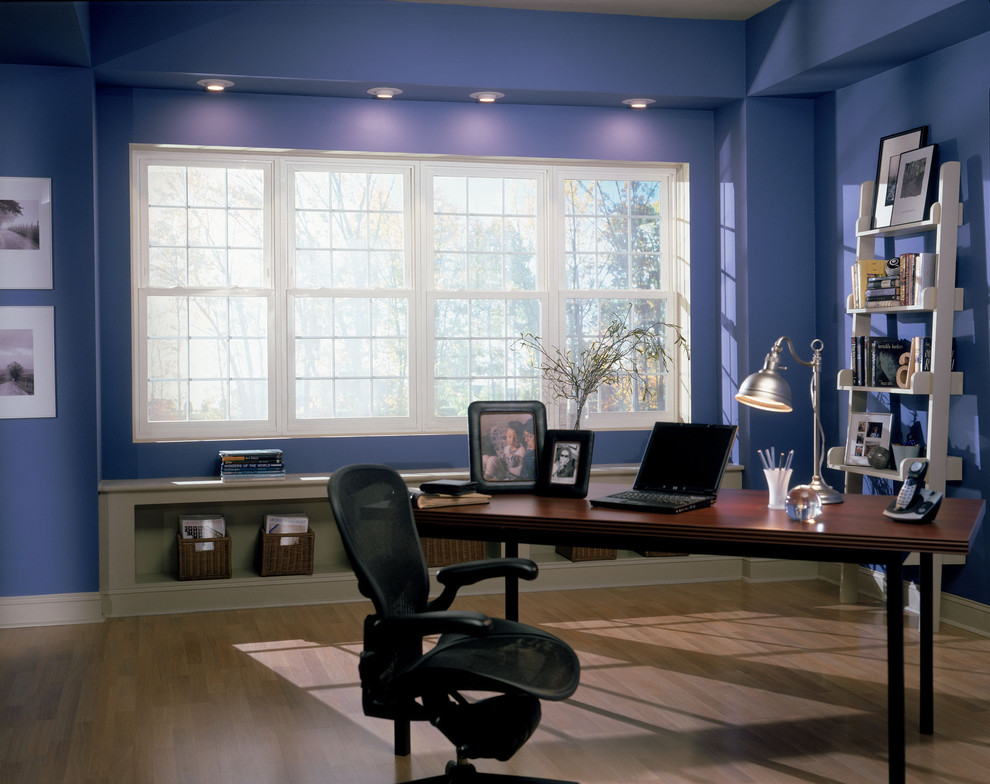 Photo of a contemporary study in Dallas with blue walls, medium hardwood flooring and a freestanding desk.