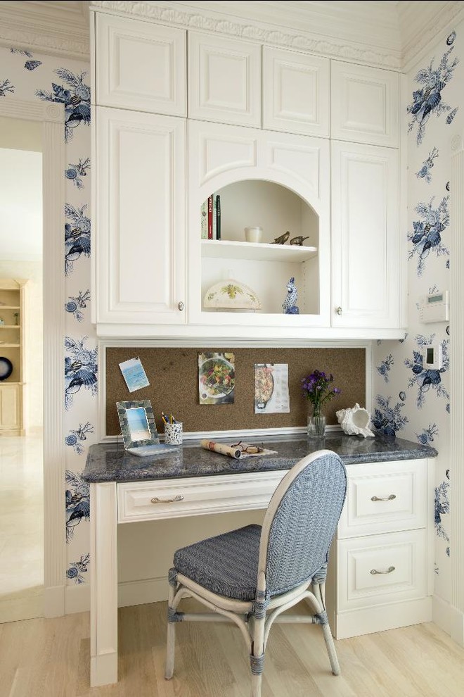 Ejemplo de despacho clásico de tamaño medio sin chimenea con paredes multicolor, escritorio empotrado y suelo de madera clara