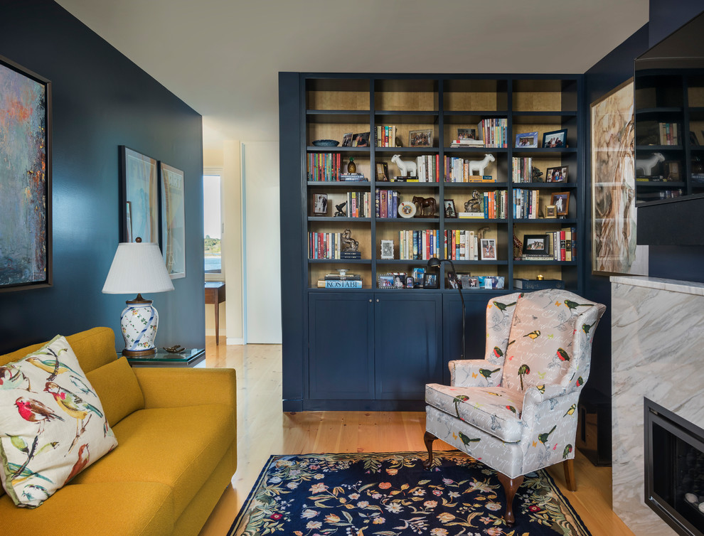 Large classic home office in Providence with a reading nook, blue walls, light hardwood flooring, a standard fireplace, a stone fireplace surround, a freestanding desk and beige floors.