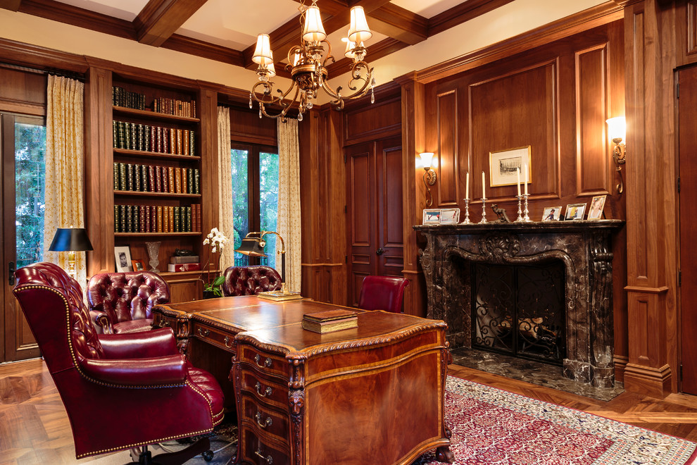 Example of a huge classic freestanding desk medium tone wood floor study room design in Los Angeles with brown walls, a standard fireplace and a stone fireplace
