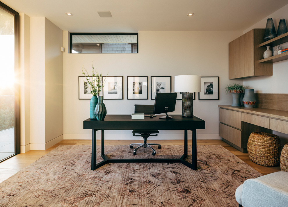 Idéer för ett stort modernt arbetsrum, med vita väggar, mellanmörkt trägolv och ett inbyggt skrivbord