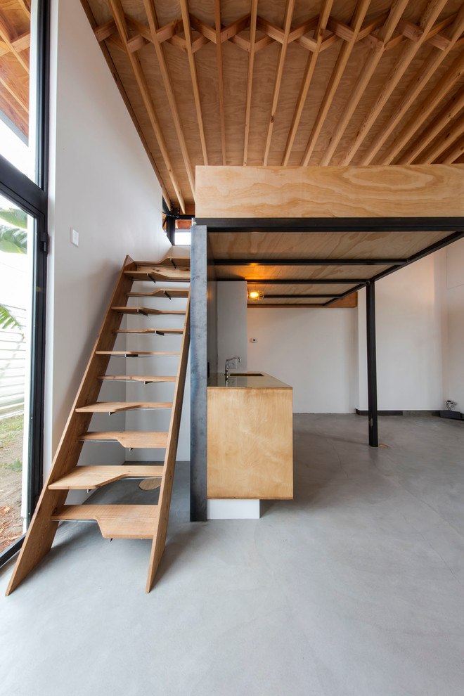 Foto de despacho minimalista con paredes blancas y suelo de cemento