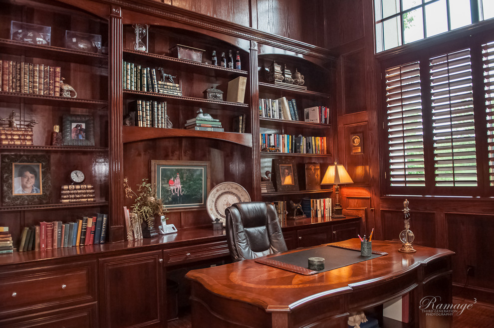 Large traditional study in Other with dark hardwood flooring, a freestanding desk and no fireplace.