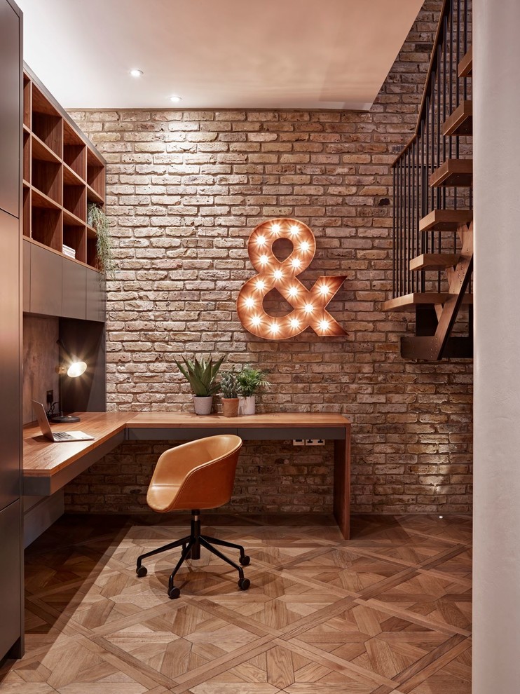 Kleines Industrial Arbeitszimmer ohne Kamin mit Arbeitsplatz, hellem Holzboden und Einbau-Schreibtisch in London