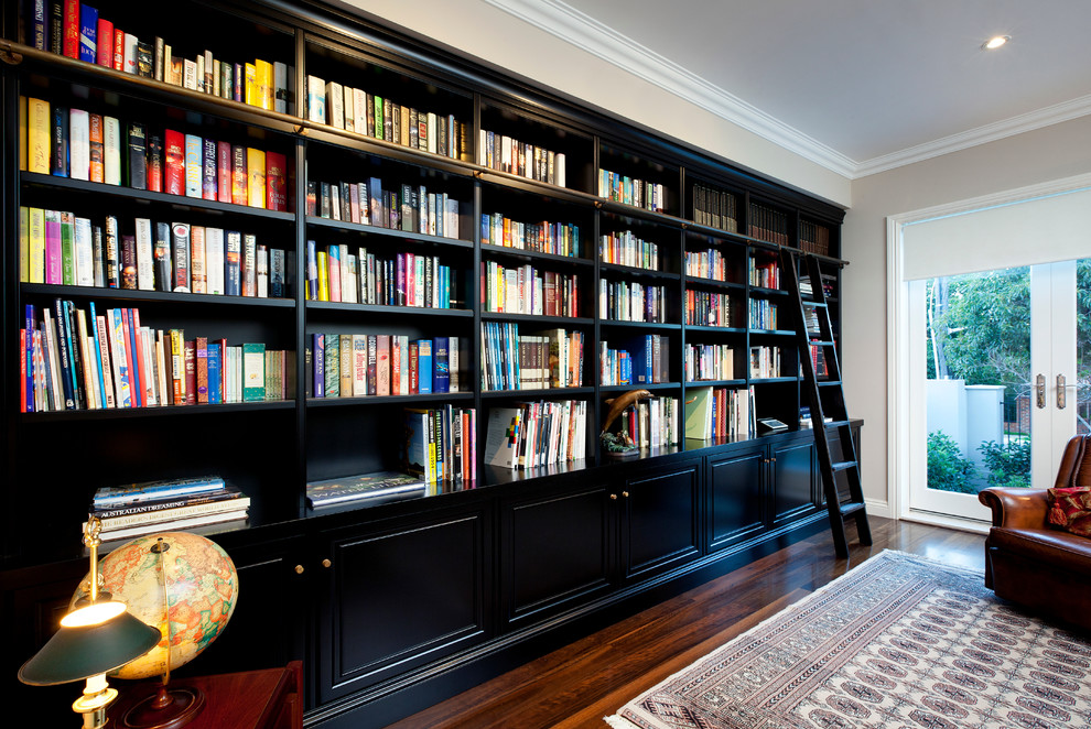 Inspiration för mycket stora klassiska arbetsrum, med ett bibliotek och mörkt trägolv