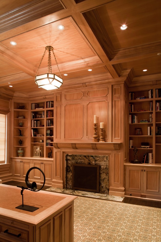 Example of a mid-sized transitional dark wood floor home office library design in DC Metro with brown walls, a standard fireplace and a wood fireplace surround