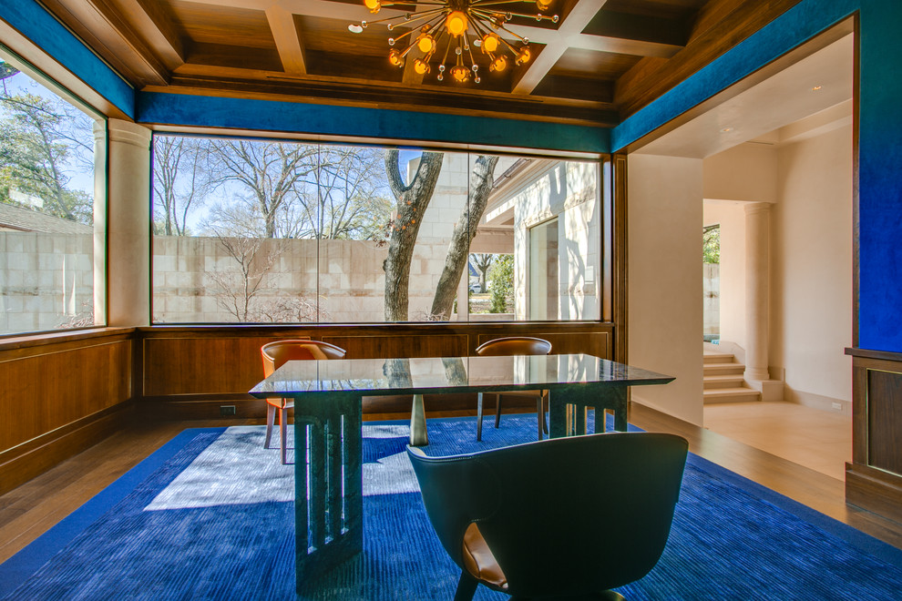 This is an example of a large retro study in Dallas with blue walls, medium hardwood flooring, no fireplace and a freestanding desk.