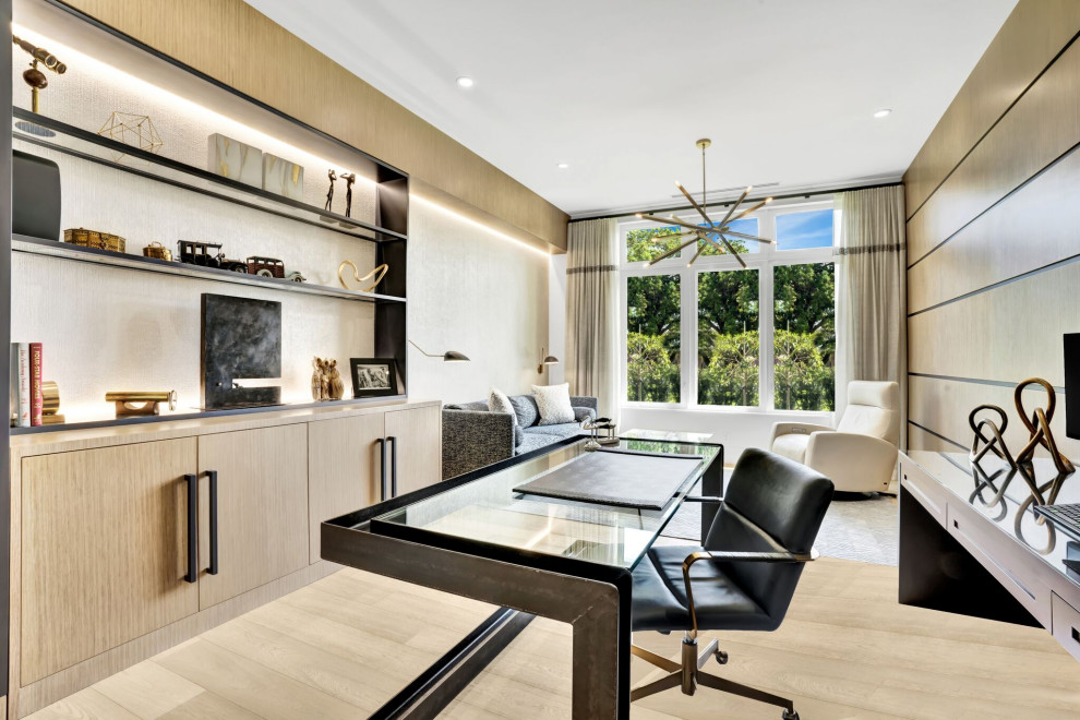 Design ideas for a large contemporary study in Miami with beige walls, light hardwood flooring, a freestanding desk, beige floors and wood walls.
