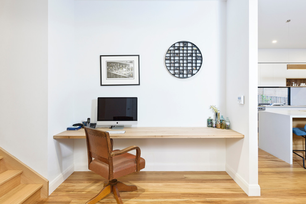 Small trendy built-in desk light wood floor study room photo in Melbourne with white walls