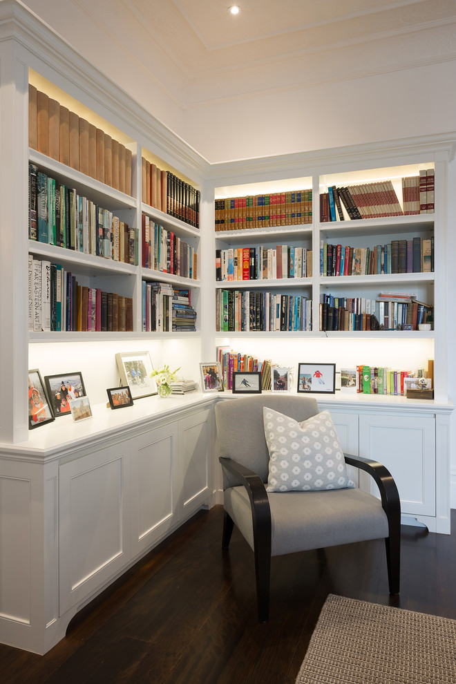 Home office library - large transitional medium tone wood floor home office library idea in Auckland with white walls