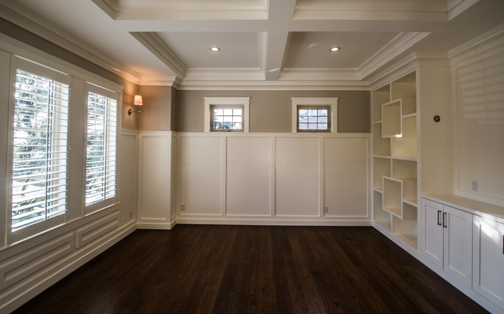 Large traditional home office in Calgary with white walls and medium hardwood flooring.