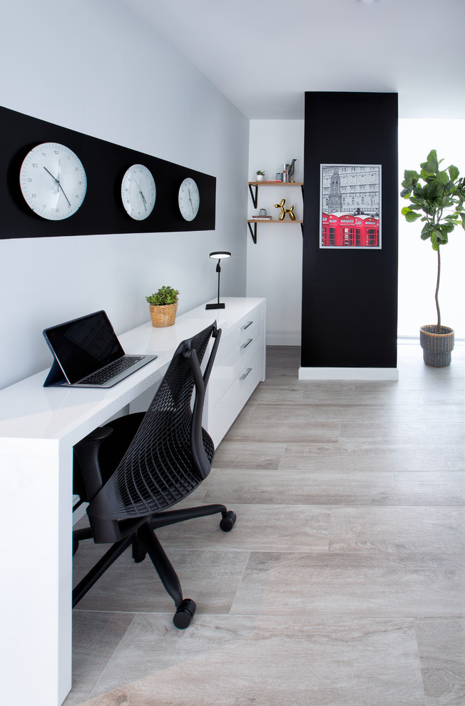 Example of a small danish freestanding desk vinyl floor home studio design in Miami with gray walls and no fireplace