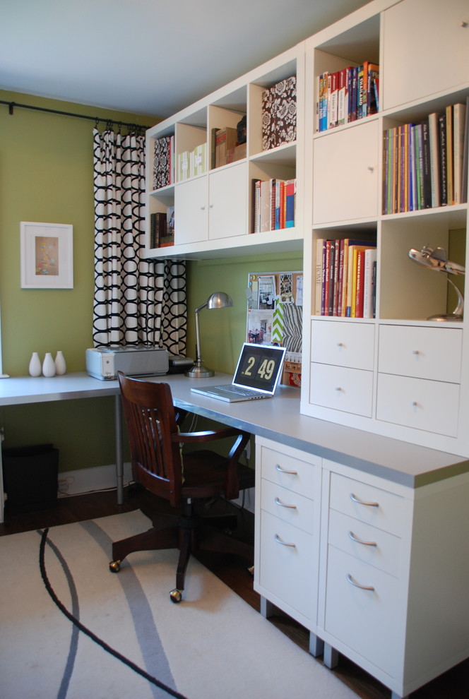 Example of a trendy built-in desk home office design in Toronto with green walls