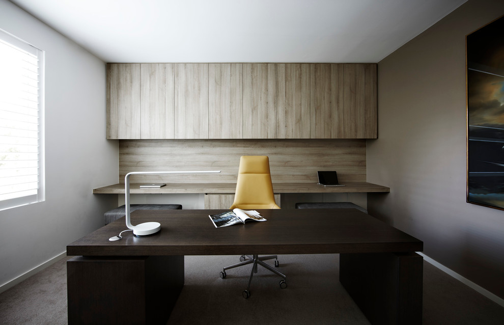 Study room - large modern freestanding desk carpeted and beige floor study room idea in Melbourne with beige walls