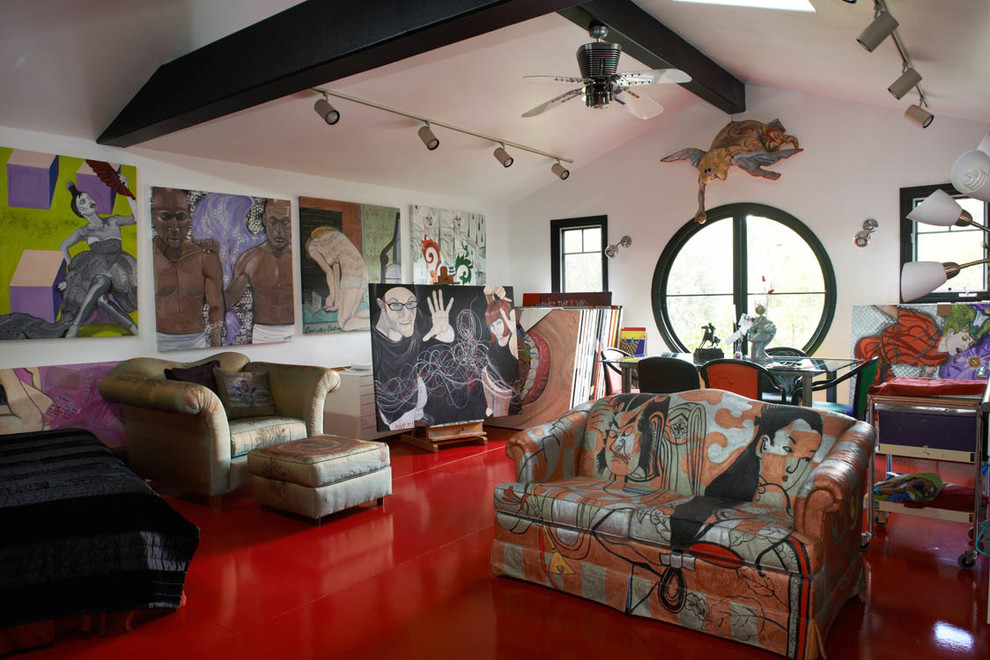Photo of an eclectic home studio in Los Angeles with white walls, a freestanding desk and red floors.