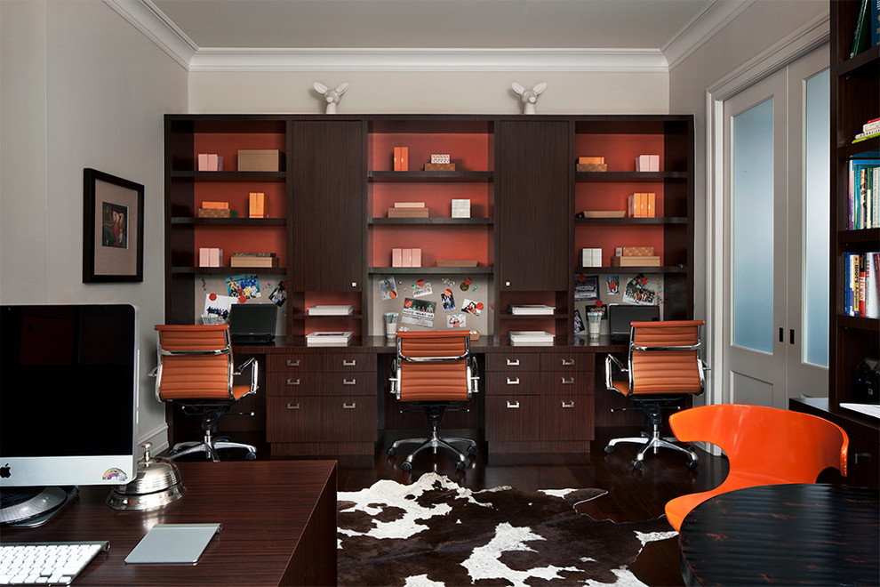 Study room - mid-sized contemporary built-in desk dark wood floor study room idea in Detroit with beige walls and no fireplace