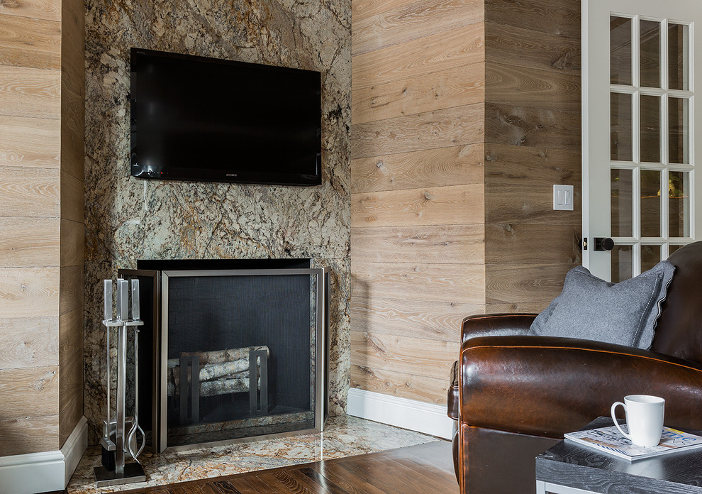 This is an example of a contemporary home office in Boston with a stone fireplace surround.