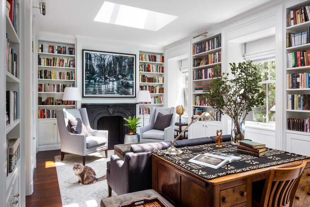 Home office library - mid-sized transitional freestanding desk brown floor and dark wood floor home office library idea in New York with a standard fireplace, a stone fireplace and white walls
