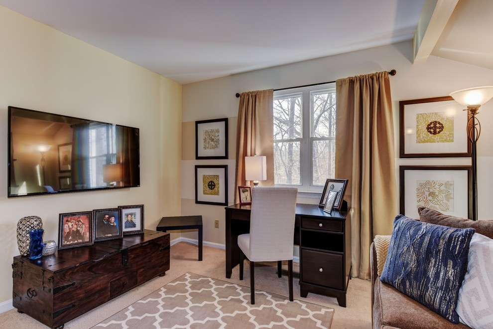Small traditional study in Philadelphia with beige walls, carpet, no fireplace and a freestanding desk.