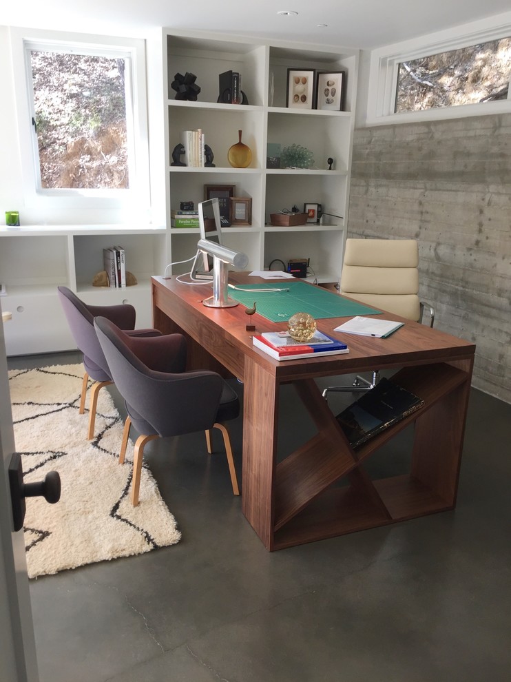 Example of a large minimalist freestanding desk concrete floor and gray floor home office design in San Francisco with white walls