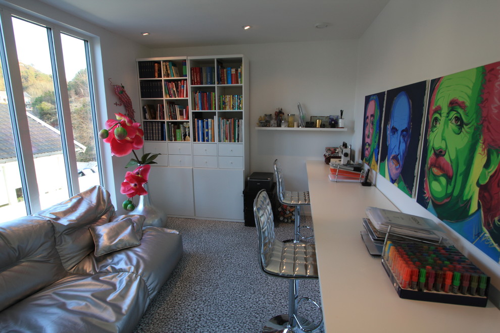 Home office - modern built-in desk carpeted home office idea in Other with white walls