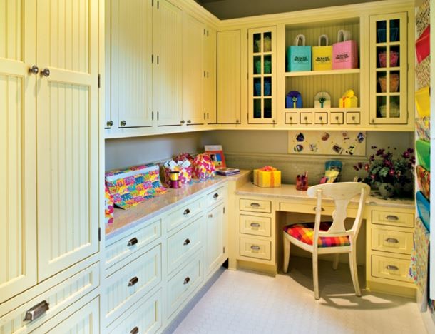 Example of a mid-sized cottage built-in desk linoleum floor craft room design in Austin with gray walls