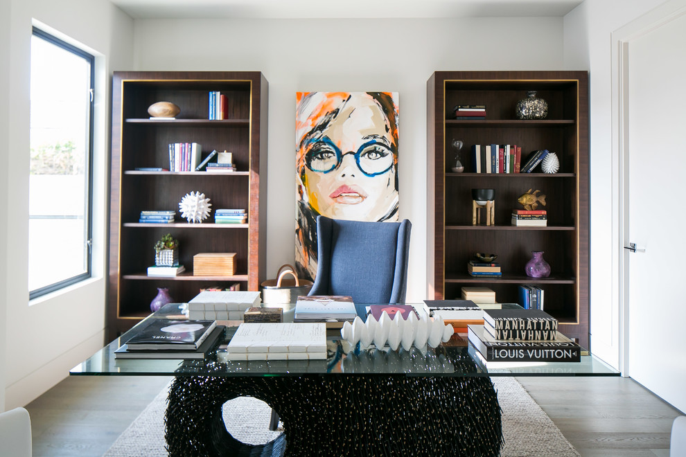 Photo of a medium sized contemporary study in Orange County with white walls, light hardwood flooring and a freestanding desk.
