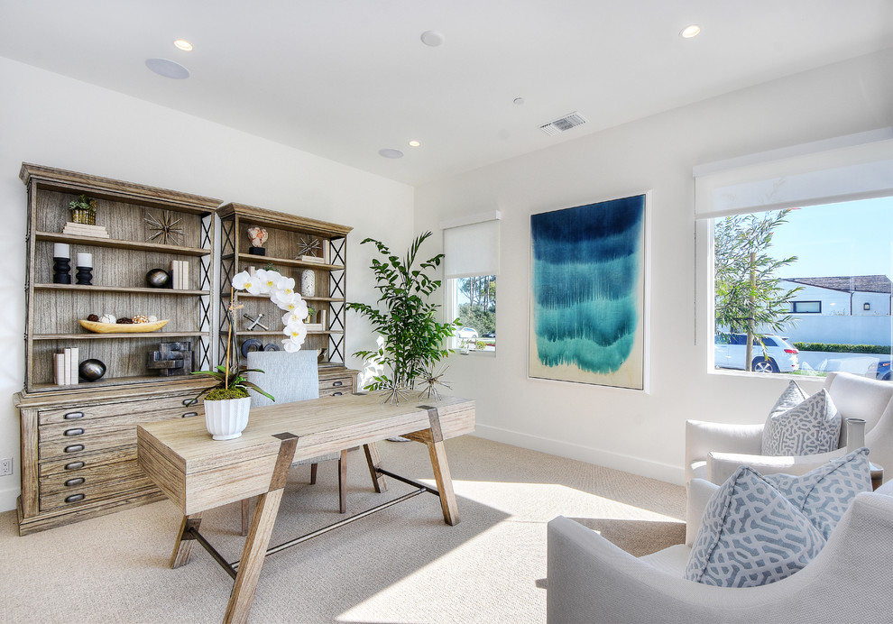 Photo of a nautical study in Orange County with white walls, carpet, a freestanding desk and beige floors.