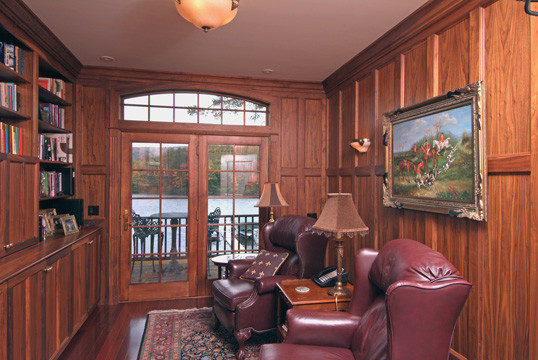 Example of a mid-sized classic dark wood floor study room design in Boston with brown walls and no fireplace
