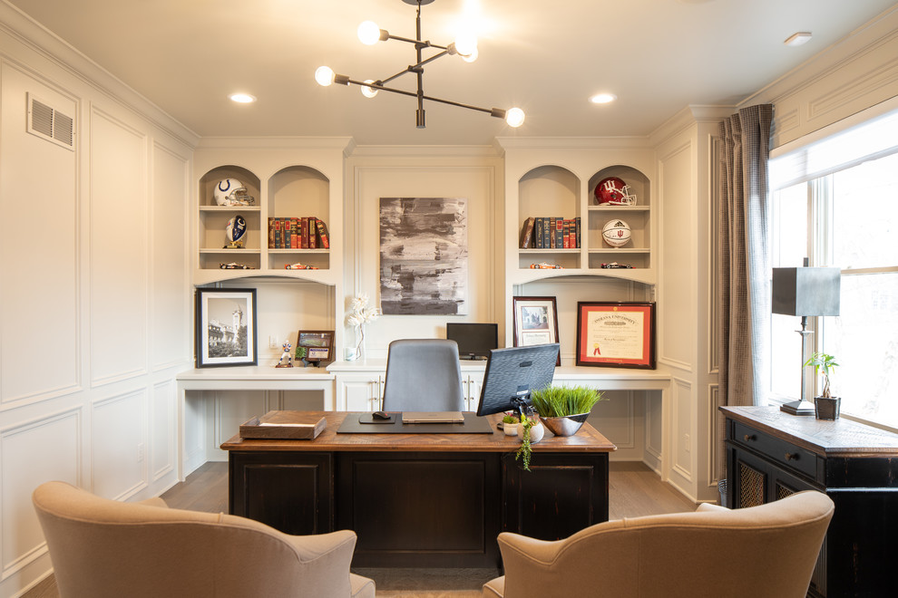 Esempio di un grande ufficio classico con pareti bianche, pavimento in legno massello medio, scrivania autoportante e pavimento marrone
